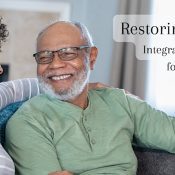 smiling elderly man sitting with younger woman