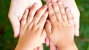 child's hands in adults hands