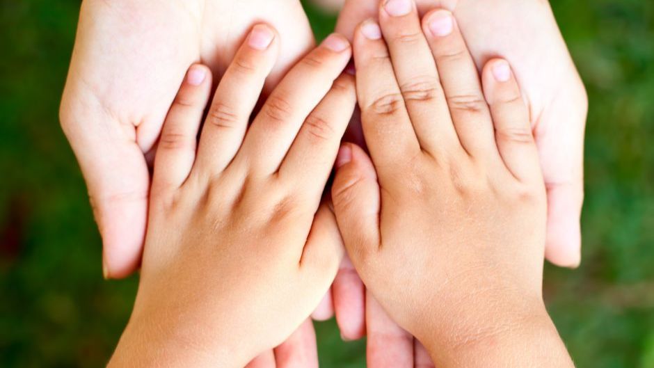 child's hands in adults hands